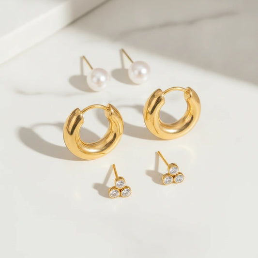BELLA EARRINGS | Place the original product large and centered on a clean white marble surface with a matching white marble background.