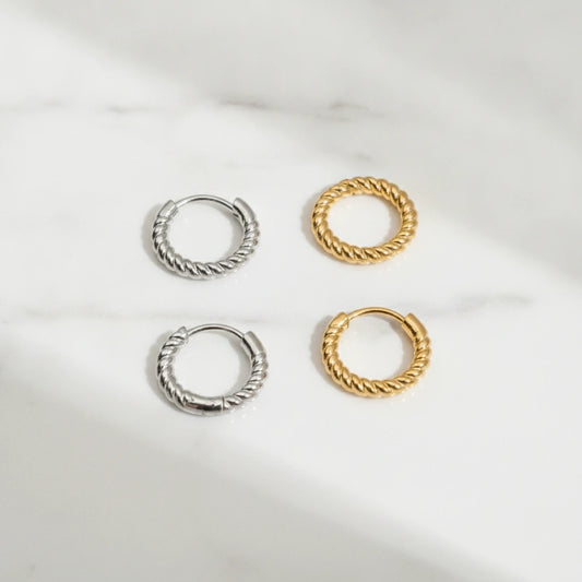 BUBBLE EARRINGS | Place the original product large and centered on a clean white marble surface with a matching white marble background.