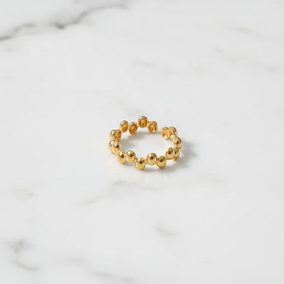 BUBBLE RINGS | Place the original product large and centered on a clean white marble surface with a matching white marble background.