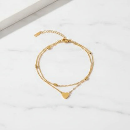 CAPRI ANKLET | Place the original product large and centered on a clean white marble surface with a matching white marble background.
