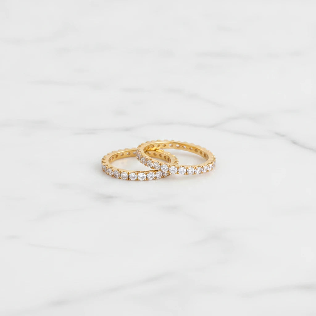 COMO RINGS | Place the original product large and centered on a clean white marble surface with a matching white marble background.