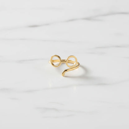 DOGS RINGS | Place the original product large and centered on a clean white marble surface with a matching white marble background.