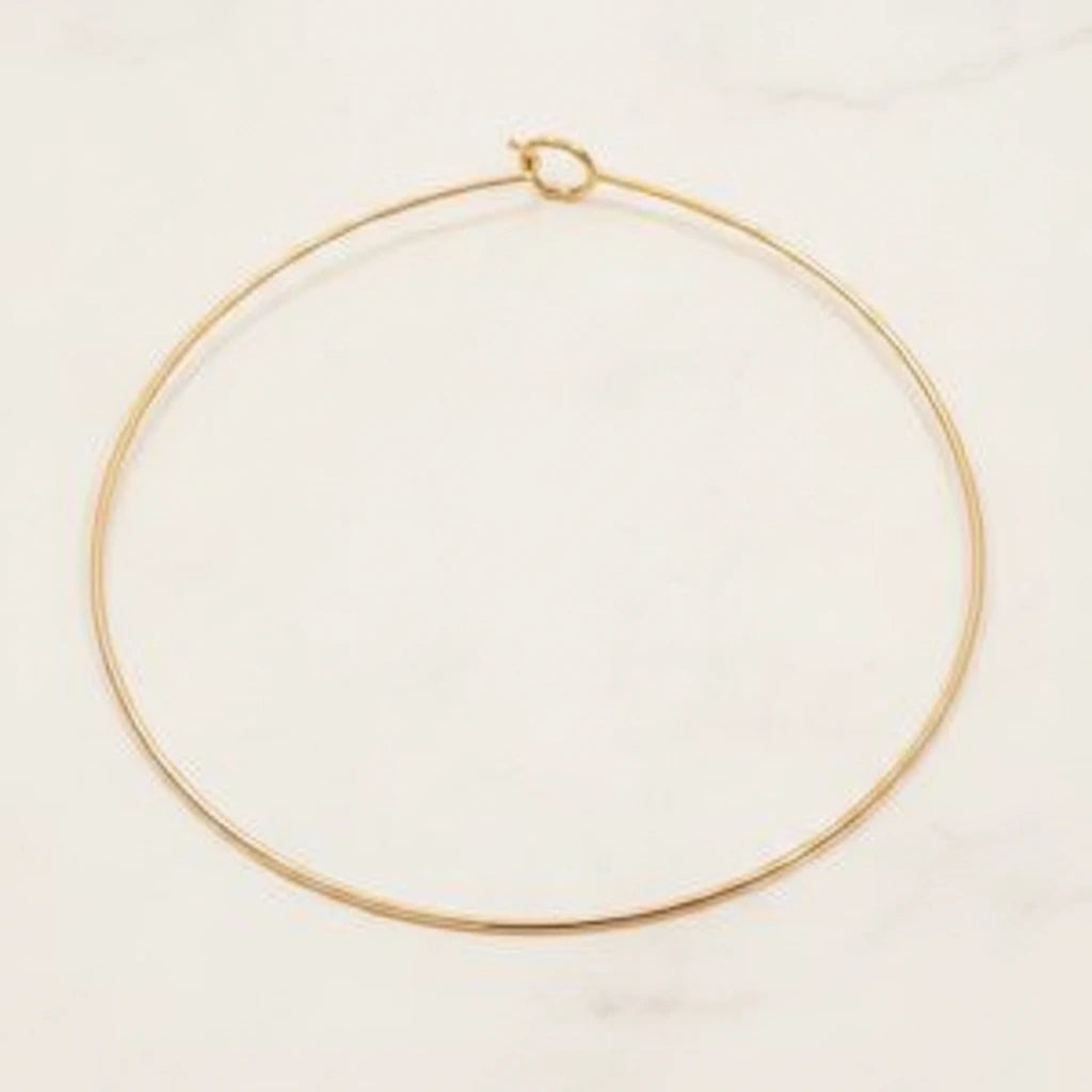 ELARA NECKLACE | Place the original product large and centered on a clean white marble surface with a matching white marble background.
