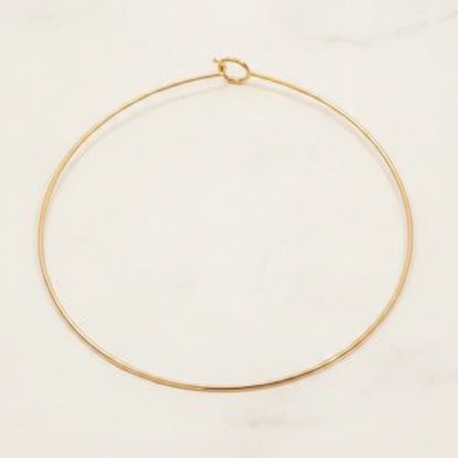 ELARA NECKLACE | Place the original product large and centered on a clean white marble surface with a matching white marble background.