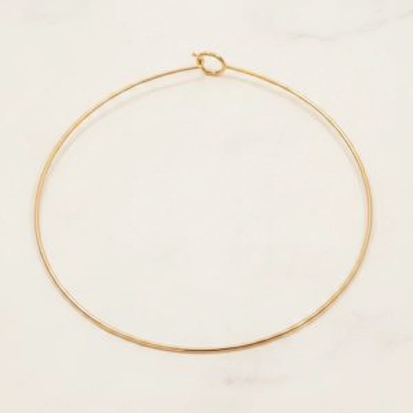 ELARA NECKLACE | Place the original product large and centered on a clean white marble surface with a matching white marble background.