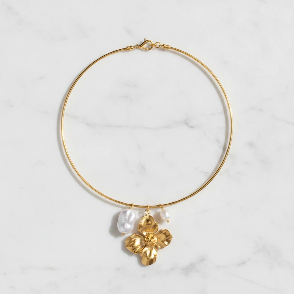 ELARA NECKLACE | Place the original product large and centered on a clean white marble surface with a matching white marble background.