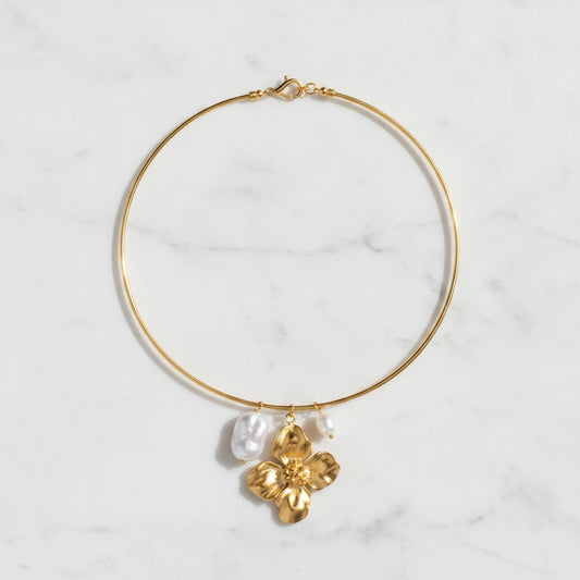 ELARA NECKLACE | Place the original product large and centered on a clean white marble surface with a matching white marble background.
