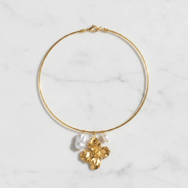 ELARA NECKLACE | Place the original product large and centered on a clean white marble surface with a matching white marble background.