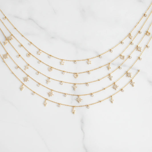FIRENZE NECKLACE | Place the original product large and centered on a clean white marble surface with a matching white marble background.