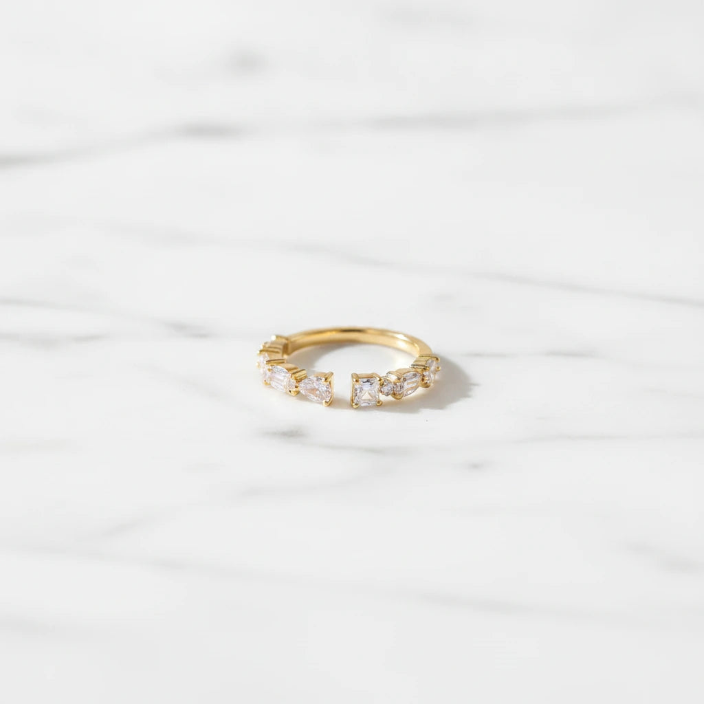 FIRENZI RINGS | Place the original product large and centered on a clean white marble surface with a matching white marble background.
