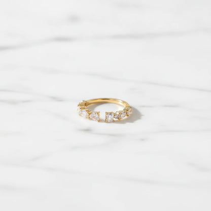 FIRENZI RINGS | Place the original product large and centered on a clean white marble surface with a matching white marble background.