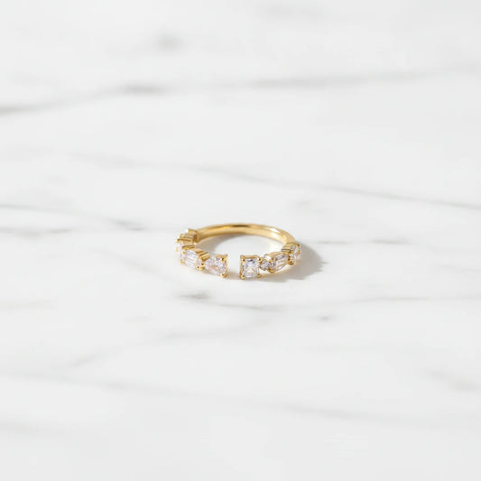 FIRENZI RINGS | Place the original product large and centered on a clean white marble surface with a matching white marble background.