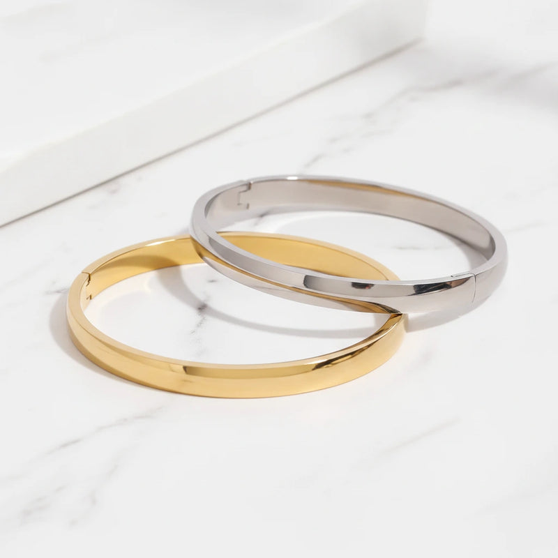 JANE BRACELETS | Place the original product large and centered on a clean white marble surface with a matching white marble background.