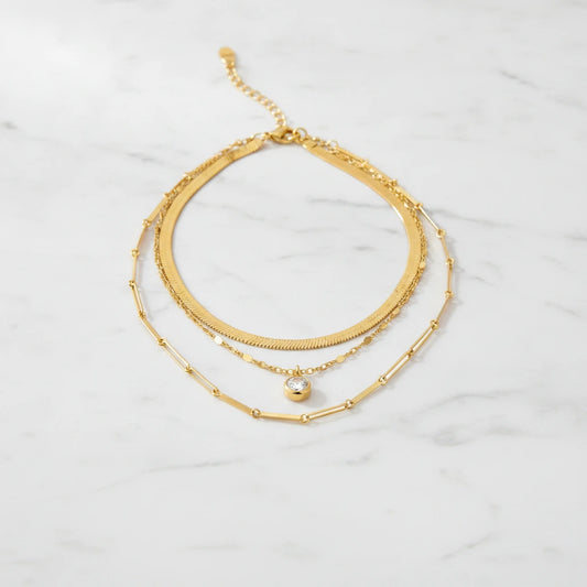 MONACO NECKLACE | Place the original product large and centered on a clean white marble surface with a matching white marble background.