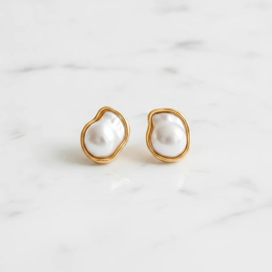 PERL EARRINGS | Place the original product large and centered on a clean white marble surface with a matching white marble background.