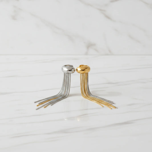 RAIN EARRINGS | Place the original product large and centered on a clean white marble surface with a matching white marble background.