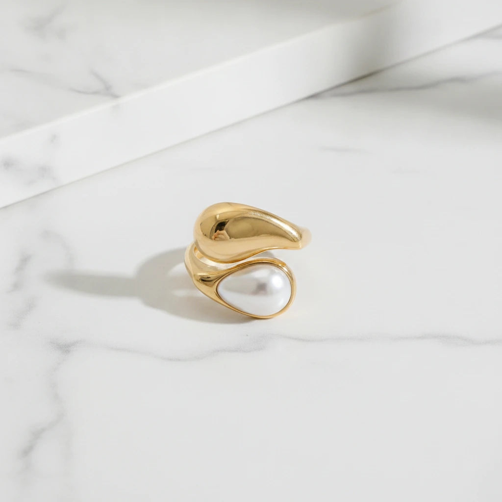 SIEANA RINGS | Place the original product large and centered on a clean white marble surface with a matching white marble background.