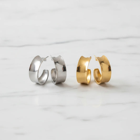 SIENA EARRINGS | Place the original product large and centered on a clean white marble surface with a matching white marble background.