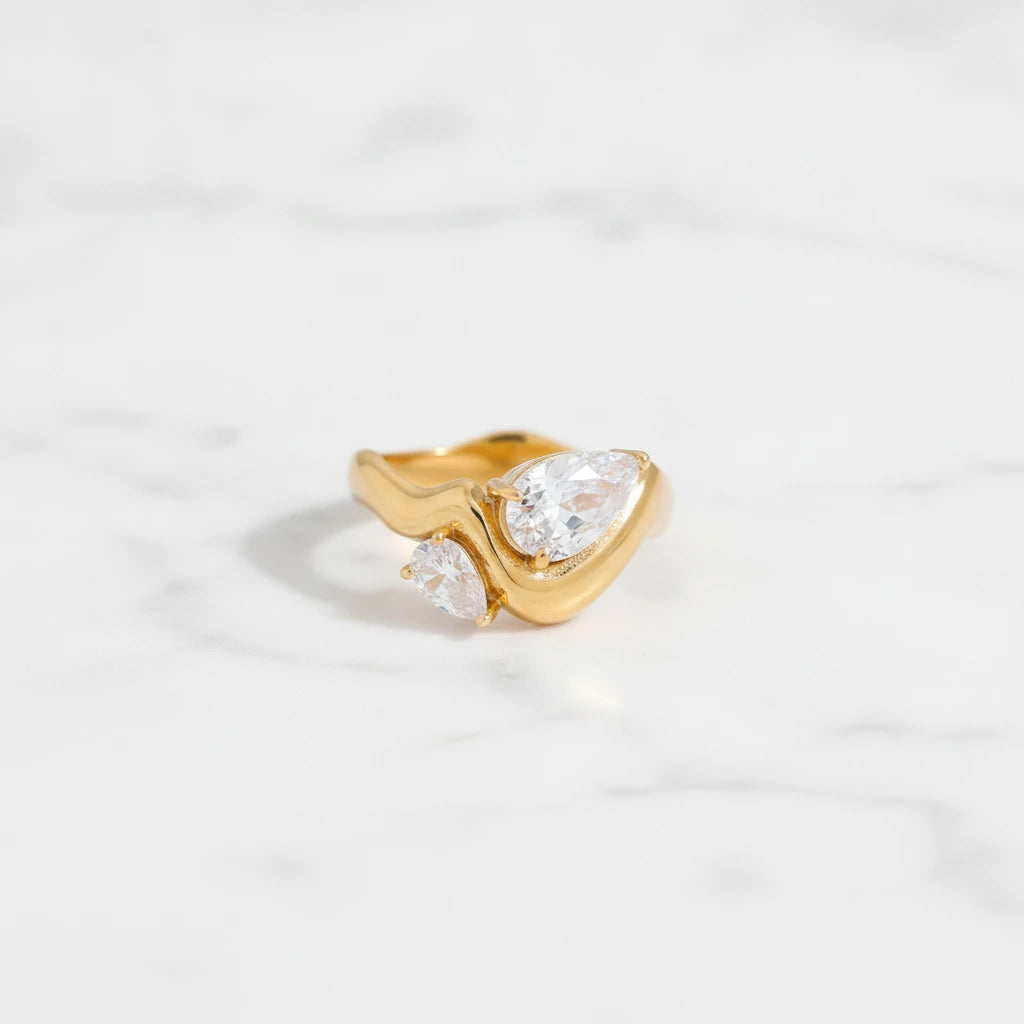 SORRENTO RINGS | Place the original product large and centered on a clean white marble surface with a matching white marble background.