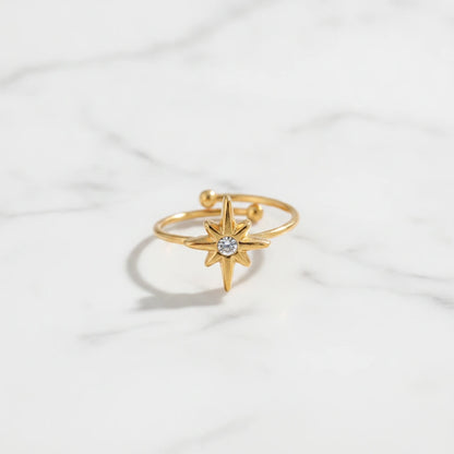 STAR RINGS | Place the original product large and centered on a clean white marble surface with a matching white marble background.