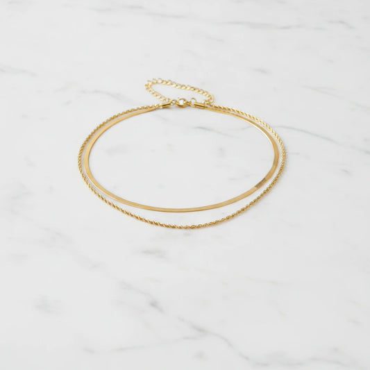 VENEZIA NECKLACE | Place the original product large and centered on a clean white marble surface with a matching white marble background.