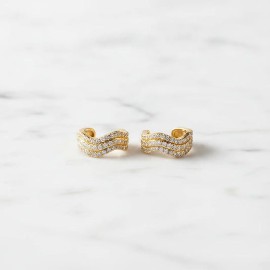 ZRCONIA EARRINGS | Place the original product large and centered on a clean white marble surface with a matching white marble background.